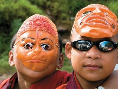 young monks at a religious festival sport trendy shades, masks