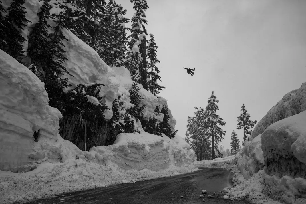 5 - A daring snowboarder soars over the famous Mount Baker road gap where adventurers fly off the cliff, seemingly just feet away from motorists, landing across the highway some 40 feet from the top.