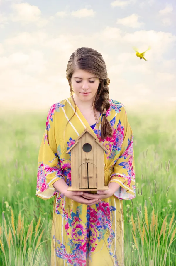 Girl holding a birdhouse thumbnail