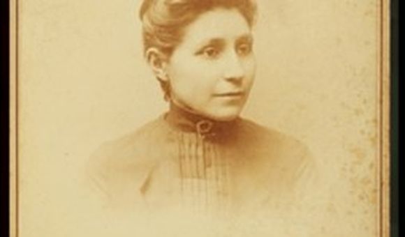 Black and white portrait of Susan La Flesche Picotte on a photo card from the shoulders up.