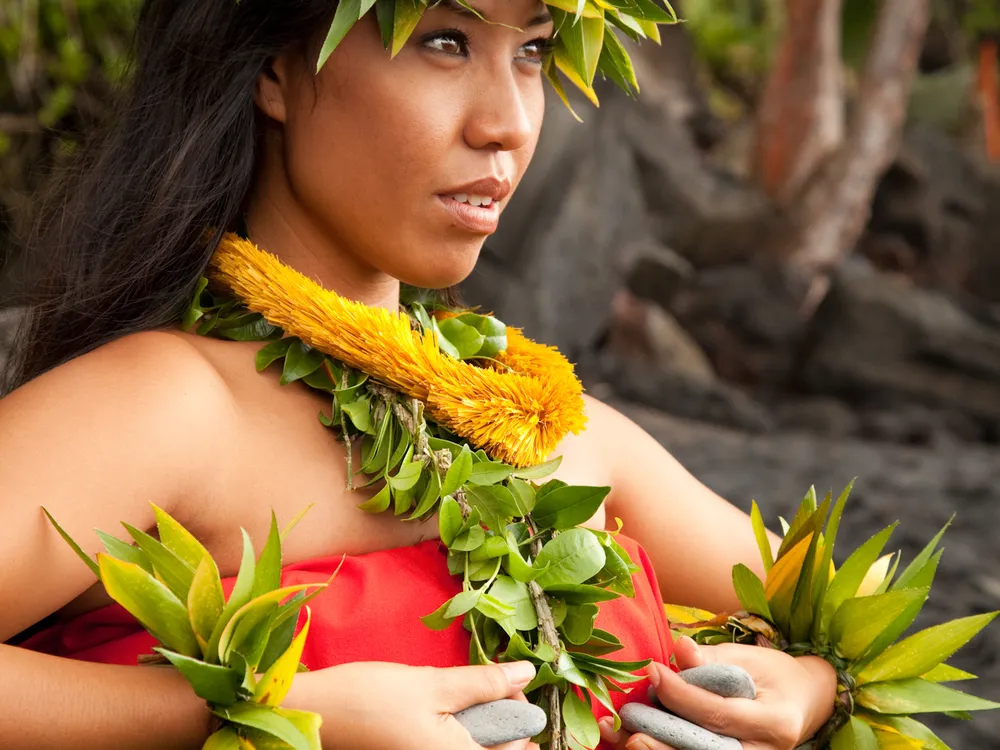Woman wearing traditional ancient hula clothing in pose. Big Island ...