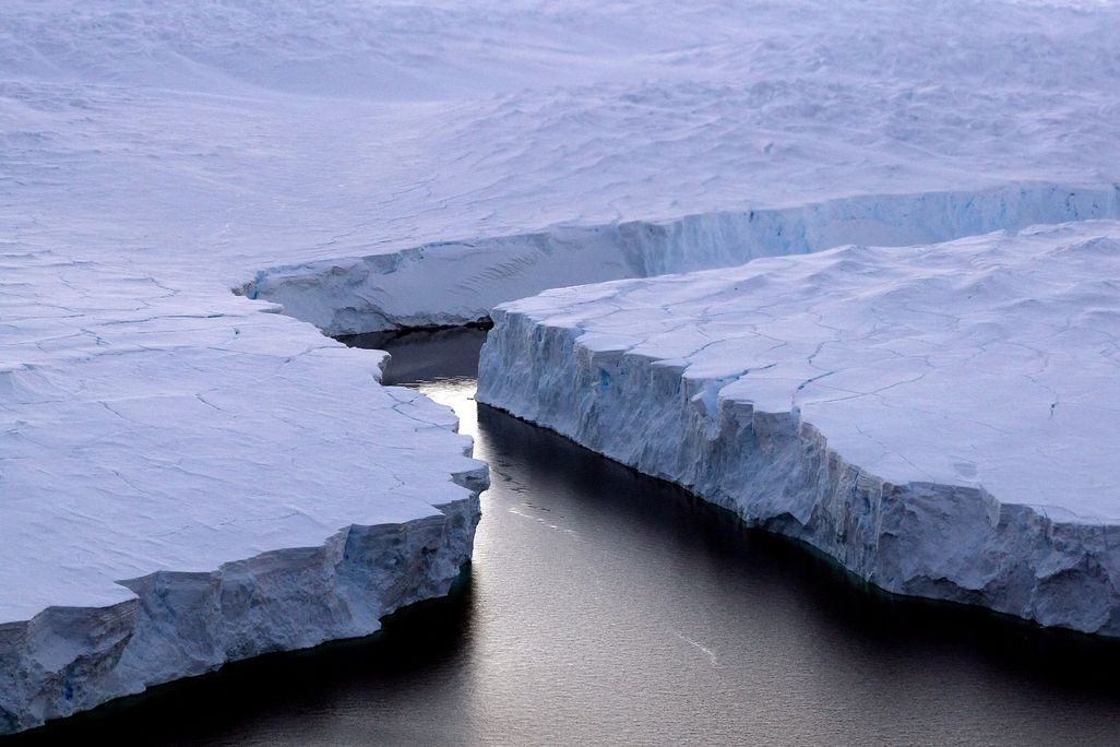 A giant iceberg breaking off from the coast