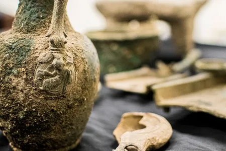 The artifacts, such as this bronze jug, are decorated with Roman religious symbols that ancient Jews would have considered idolatrous.