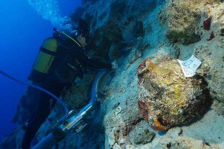 A diver handles a container during underwater archaeological excavations near Kekova Island in Turkey.