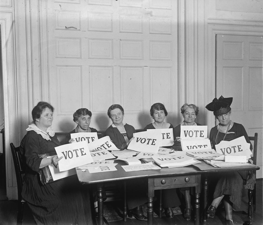 women holding VOTE signs