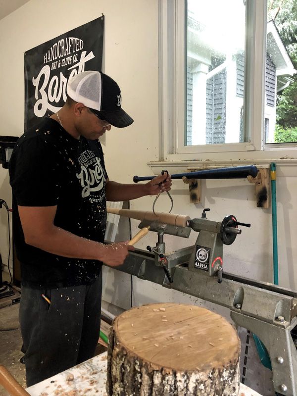 Juan Baret working on a bat