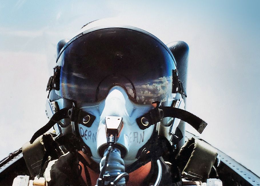 Selfie of Joy Dean in her flight helmet. Clouds are reflected in the visor.