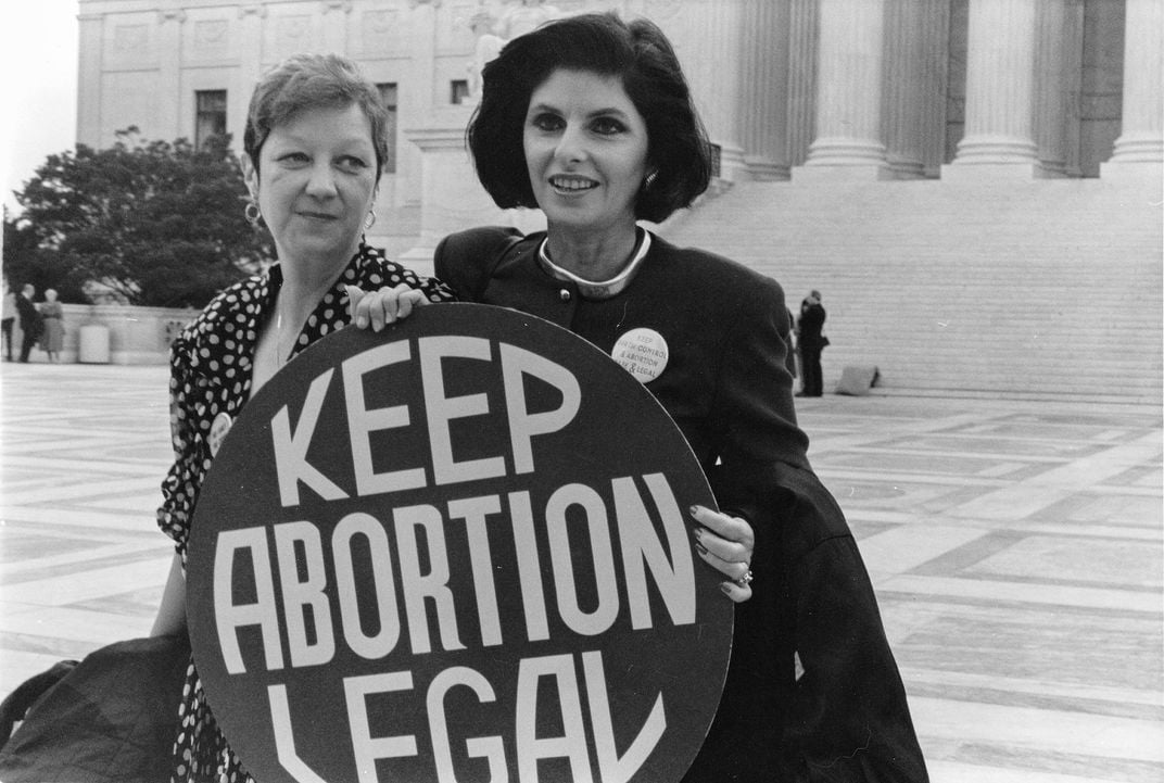 Norma McCorvey (left), the plaintiff in the 1973 Roe v. Wade case, with her attorney, Gloria Allred, outside the Supreme Court in April 1989, when the court heard arguments in a case that could have overturned Roe​​​​​​​