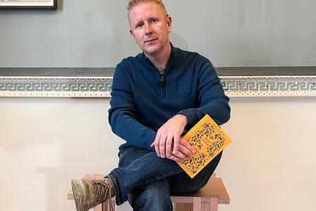 Brian Cleary poses with a newly published copy of Bram Stoker&#39;s &quot;Gibbet Hill,&quot; illustrated by&nbsp;Irish artist Paul McKinley.