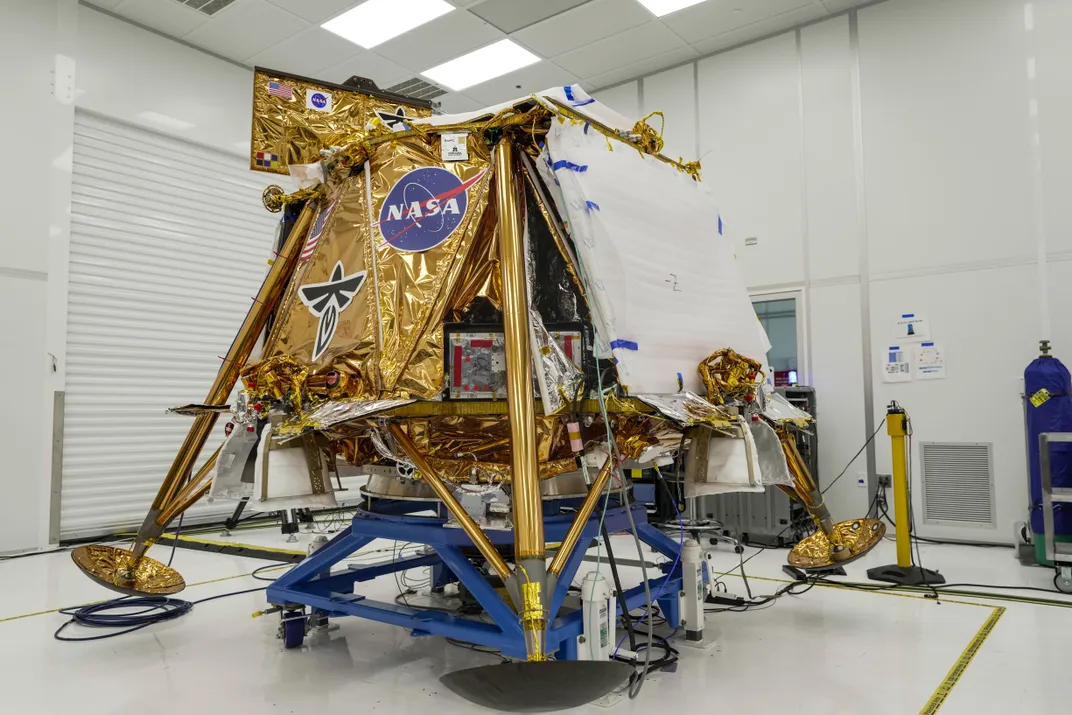 a lunar lander covered in gold foil with a nasa logo, firefly aerospace logo and american flag sticker