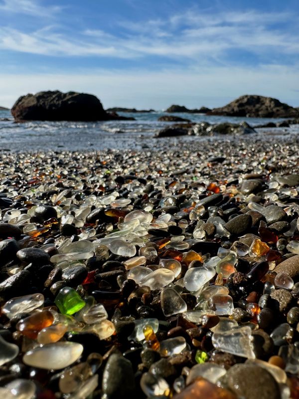 Glass pebbles catch the sunlight at Glass Beach in Fort Bragg, California. thumbnail