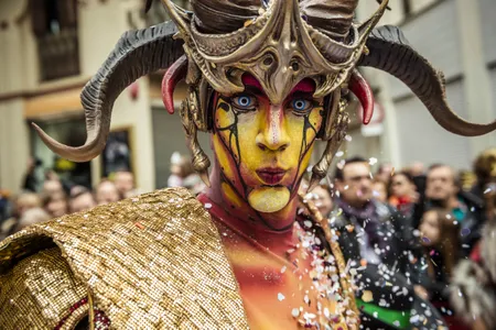 Fictitious Catalan figures known as "carnestoltes" dance in the street during the Carnival parade in Sitges, Spain.