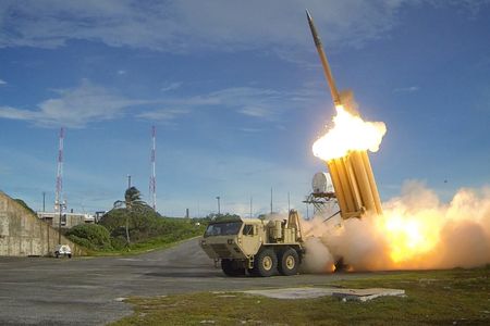 An interceptor missile leaps from its launcher on Kwajelein Atoll to smash into a target impersonating a medium-range ballistic missile.