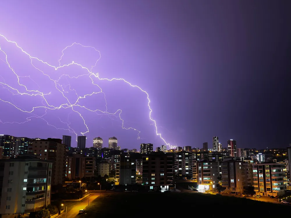 Lightning in the night sky above buildings