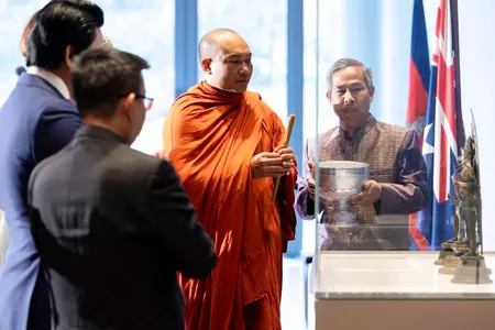 Phin Sokol, the abbot of Khemararangsi Buddhist Temple, performs a Buddhist blessing at a ceremony for the repatriation of three bronze statues that were previously part of the collection of the National Gallery of Australia.