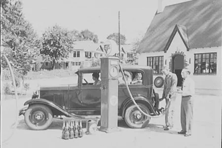 A family of four buying gas at a service station.