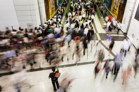 People seem to flow like river currents through the Central MTR subway station in Hong Kong.