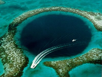 The Great Blue Hole, a 354-foot deep cavern and popular dive site in Belize's Lighthouse Reef