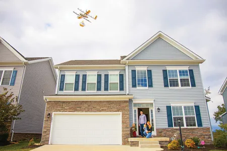 A Wing 7000 drone makes a delivery to a Christiansburg home from its designated 23-foot hover altitude, where it will lower the up to three-pound package on a breakaway tether. It flies 130 feet above ground level.