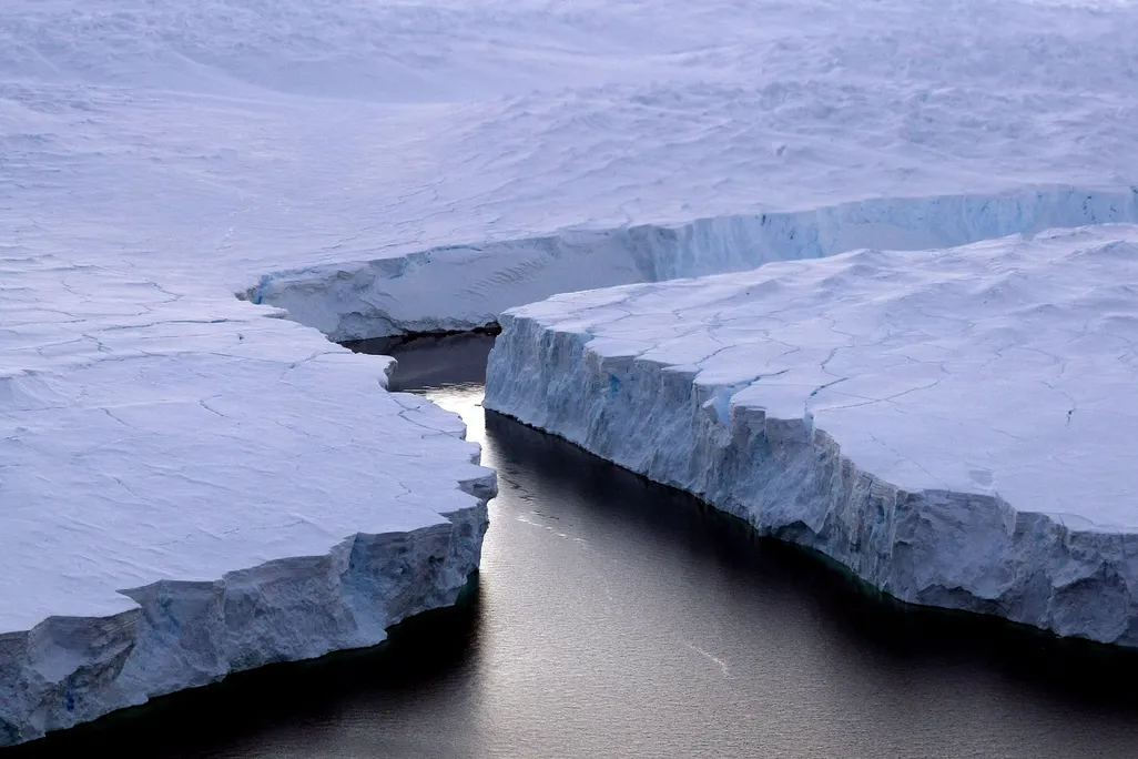 A giant iceberg breaking off from the coast