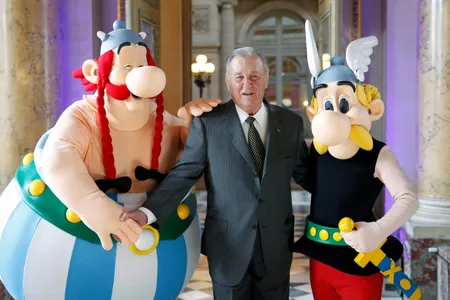 Cartoonist Albert Uderzo poses with Asterix (R) and Obelix (L) prior to a press conference at the Monnaie de Paris on March 25, 2015.
