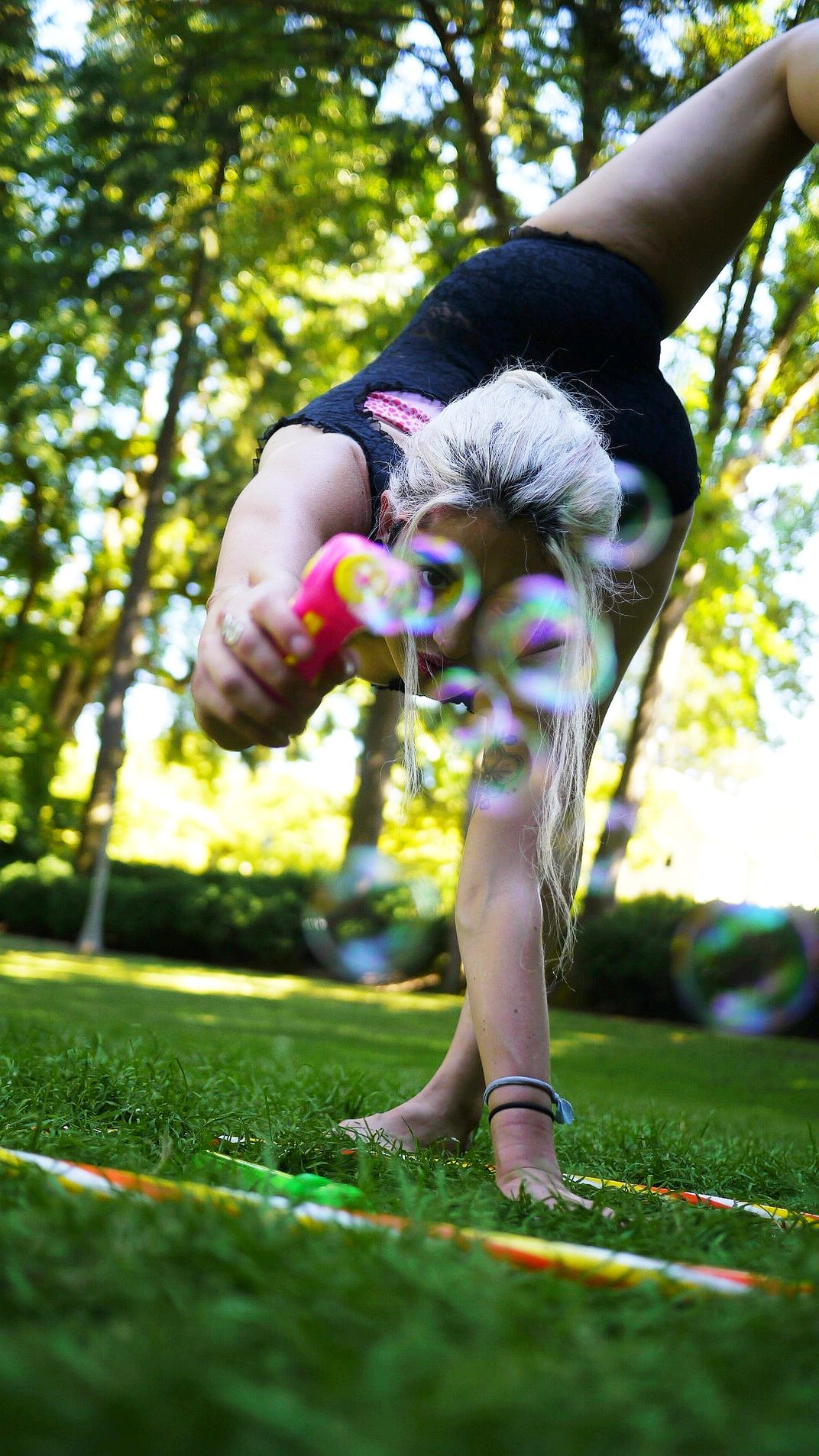 A Contortionist Playing with Bubbles in a Park. | Smithsonian Photo ...