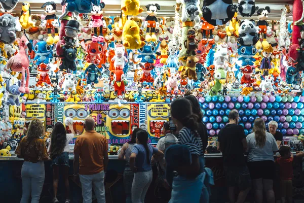 Prize Wall Buzz at a Busy Fairground Stall thumbnail
