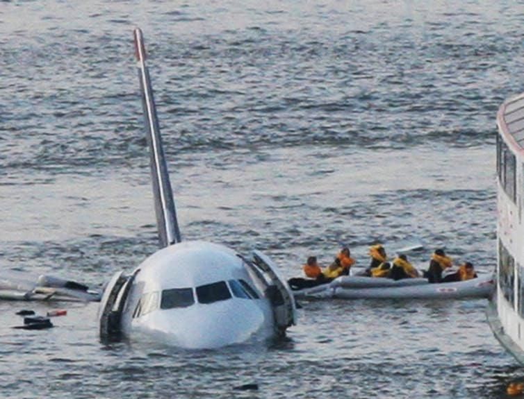 US Airways Flight 1549 passengers evacuate in the water after an emergency landing.