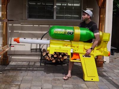 Engineer Mark Rober posing with his Super Soaker creation