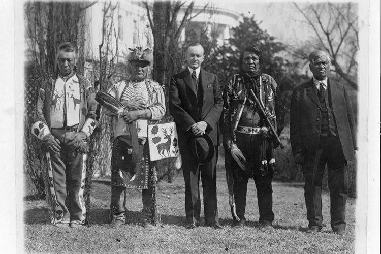 Calvin Coolidge poses with Native American leaders on the White House lawn in 1925