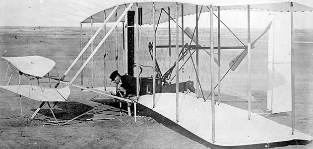 Wilbur Wright at the controls of the 1903 Wright Flyer, Kitty Hawk, North Carolina, December 14, 1903.