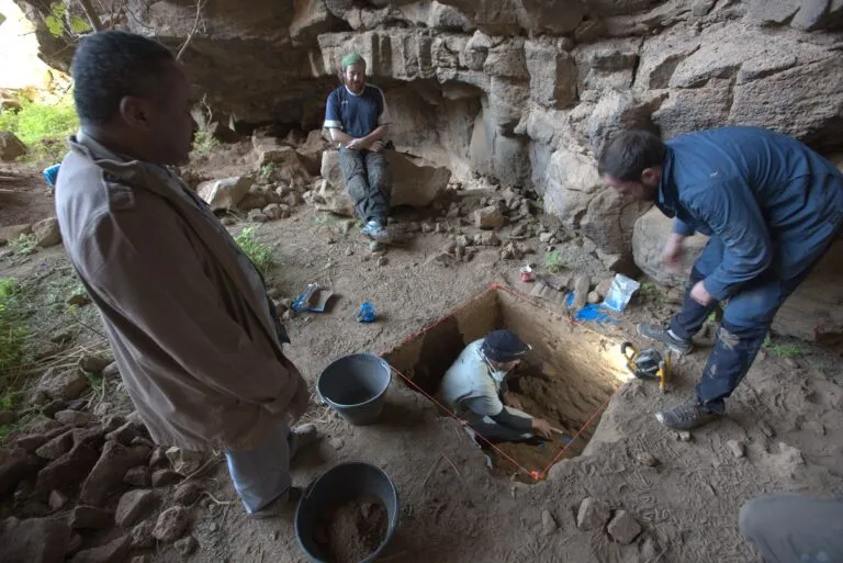researchers in a cave digging