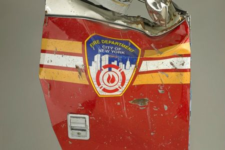 When the first hijacked plane crashed into the World Trade Center, the New York Fire Department immediately responded. Officers set up a command center in the lobby of the north tower and bravely rushed up the stairs to rescue the trapped occupants and put out the raging fires. When the towers collapsed, numerous trucks were crushed, and 343 members of the New York Fire Department were killed. 

This door is from a FDNY rescue pumper truck destroyed in the World Trade Center collapse. The truck belonged to Squad One of Brooklyn, part of FDNY’s Special Operations Command, an elite group of firefighters who respond to unique fire and emergency situations. Squad One lost 12 members on September 11.

Caption from the National Museum of American History's Bearing Witness to History.