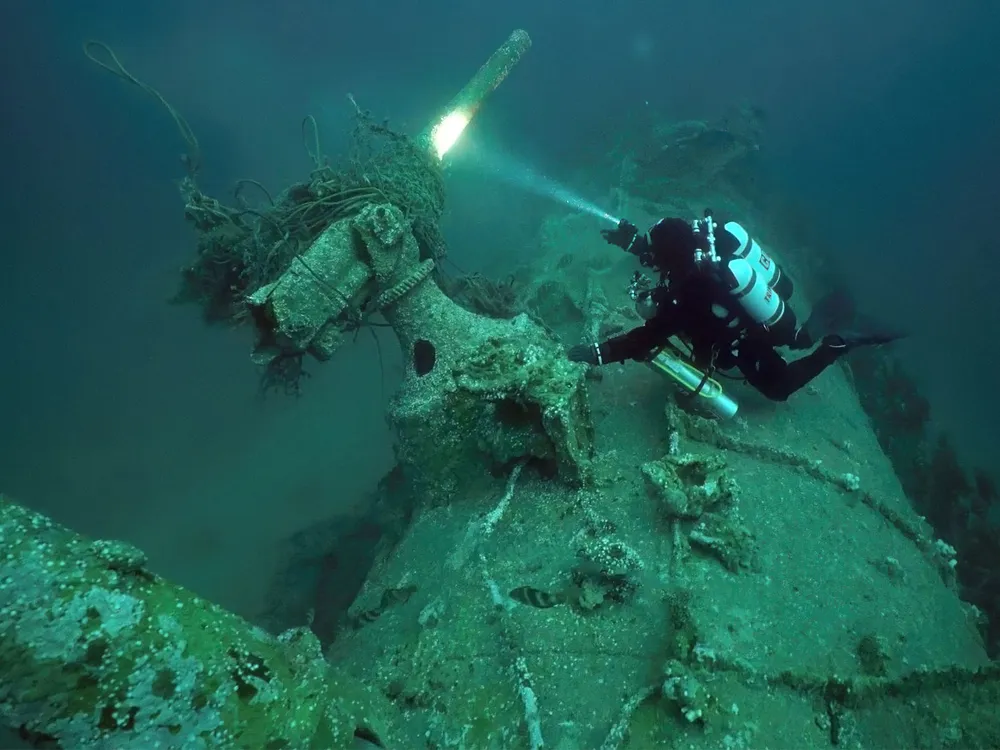 Diver Chris de Putron inspects the wreck of the German submarine UC-18​​​​​​​, which sank off the Channel Islands in February 1917.