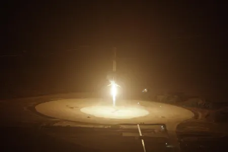 The first stage of a Falcon 9 rocket fires its engine before landing back at Cape Canaveral, December 21, 2015.