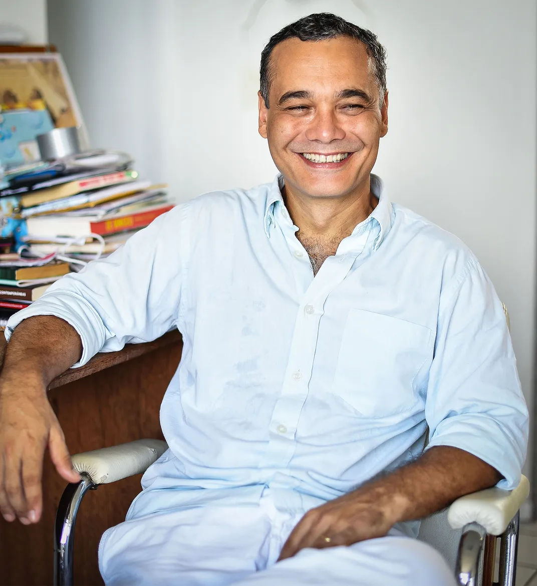 a headshot of Sidarta Ribeiro in front of his desk