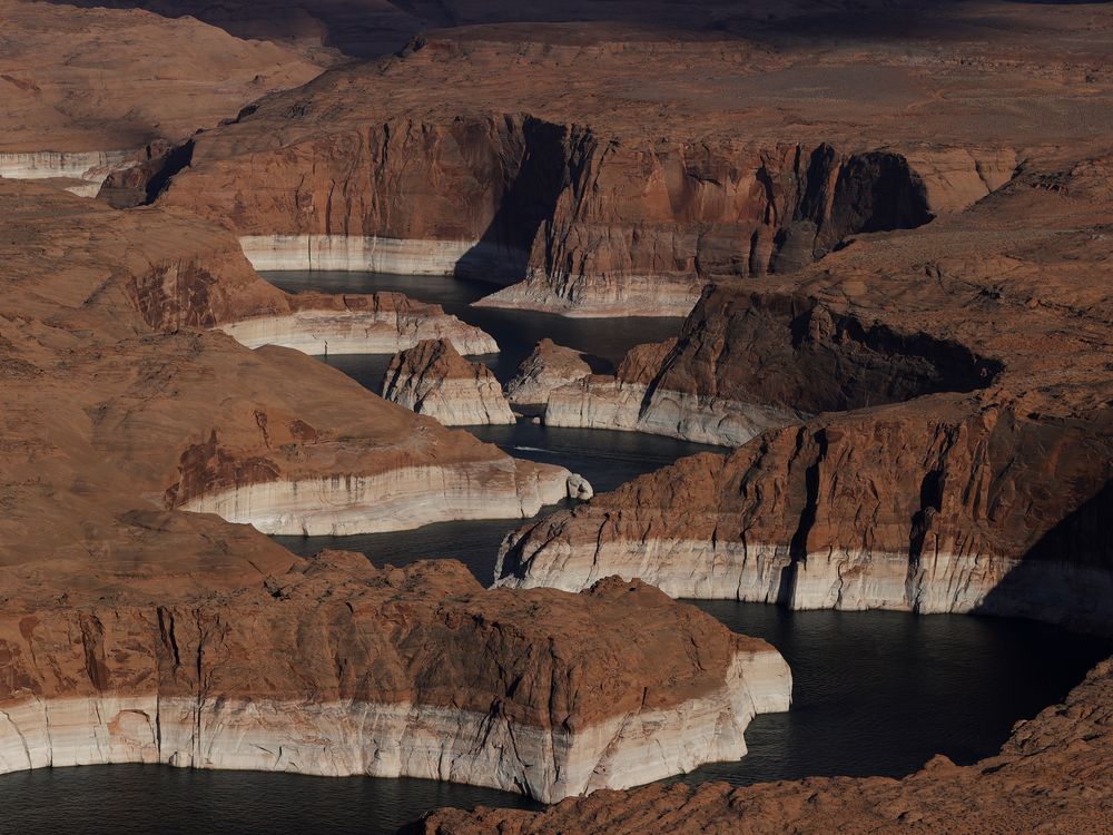 In this aerial view, The tall bleached "bathtub ring" is visible on the rocky banks of Lake Powell on June 24, 2021 in Page, Arizona.