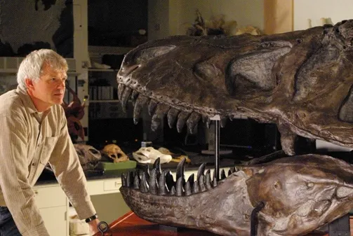 Paleontologist Philip Currie poses with a tyrannosaur skull.