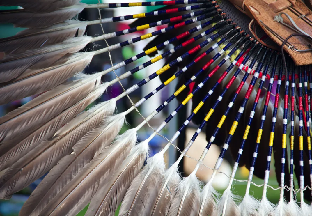 close up detail of a feathers and colorful beads