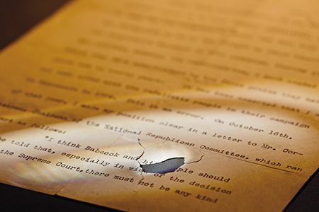 The first page of Theodore Roosevelt's speech that was damaged when a bullet tore through it.