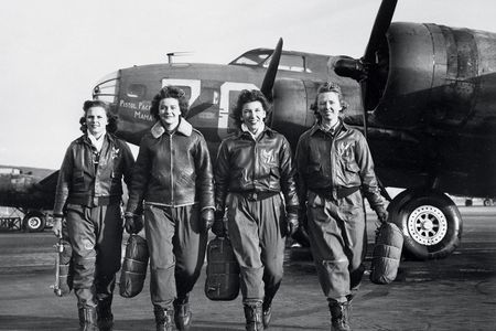  Carrying their parachutes, Women Airforce Service Pilots (left to right) Frances Green, Margaret Kirchner, Ann Waldner, and Blanche Osborn pass a line of Boeing B-17s at a U.S. Army airfield in Columbus, Ohio, where in 1944 they were training to ferry the bombers.