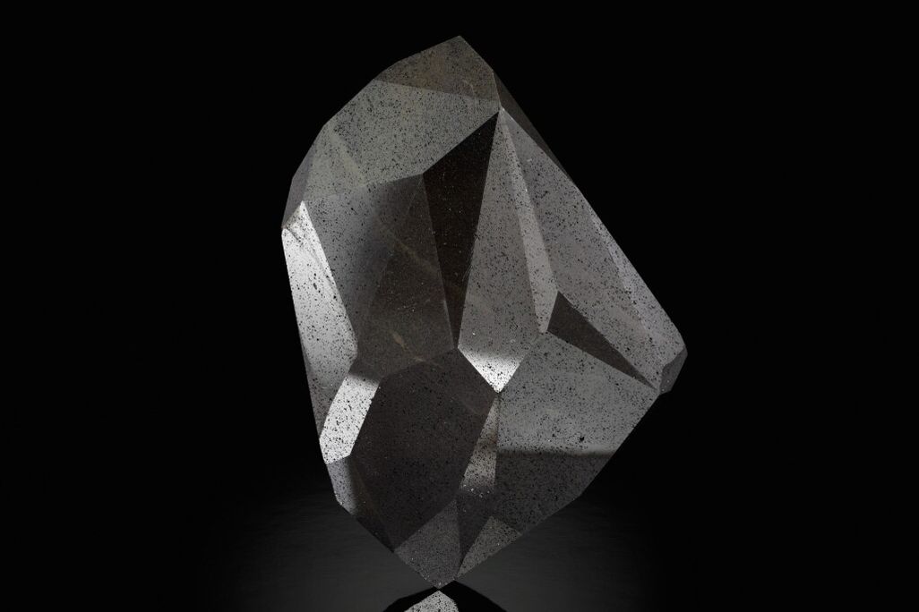 A large black gemstone with 55-facets