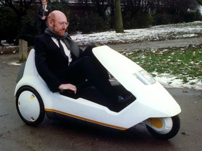 Inventor Sir Clive Sinclair demonstrates his battery-assisted pedal powered tricycle at Alexandra Palace, London.