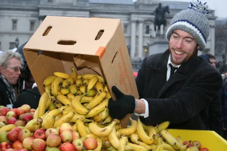 Activist Tristram Stuart adds to a collection of fruits during an event in Trafalgar Square designed to highlight food waste by feeding 5,000 people on rejected supermarket food.