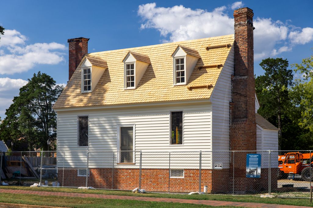 Small white building with fencing in front of it