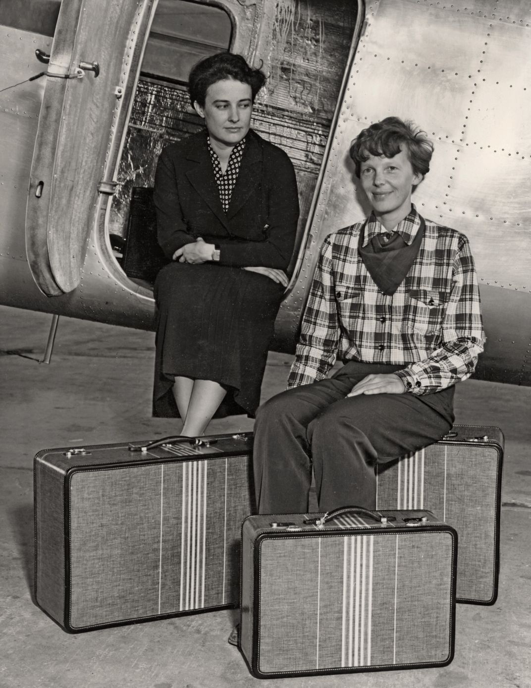 Helen Richey and Amelia Earhart modeling luggage