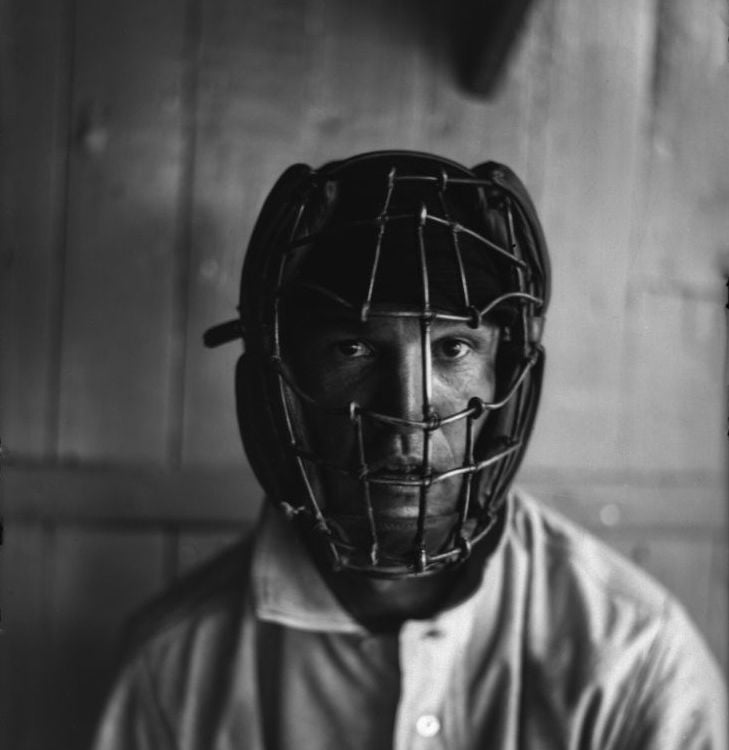 A player wearing an old-fashioned catcher's mask