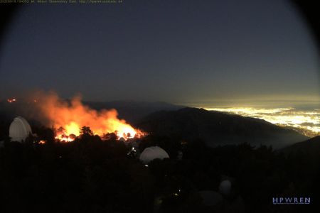 A webcam view of Mount Wilson Observatory's trademark white domes, with fires raging in the background on September 19.