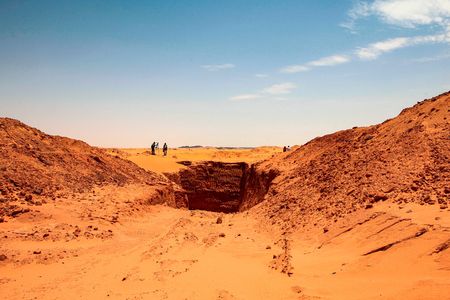 The vast trench dug by treasure hunters is visible at the center of this image.