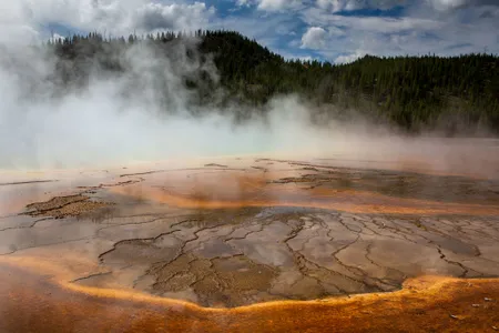 Minerals and algae form patterns in the scalding hot water at Grand Prismatic Spring in Yellowstone National Park&#39;s Midway Geyser Basin.&nbsp;Yellowstone National Park has more than 10,000 thermal features, making it the largest concentration of active geysers in the world.